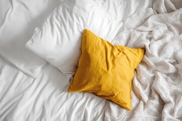 Overhead View of a White Pillow and Yellow Pillow on a White Bedding Set with Textured White Blanket Minimalist Neutral Tone