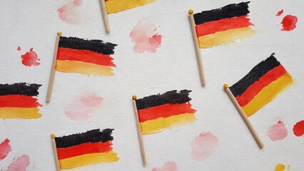 Watercolor pattern of small German flags with splashes