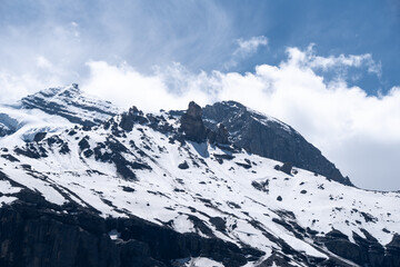 Dramatic snow-capped peak above Kandersteg - Bernese Alps mountain landscape with deep-blue sky