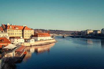 Obraz premium Cityscape of Prague with Vltava River, beautiful buildings of Mala Strana and Manesuv bridge in morning light, Czech Republic
