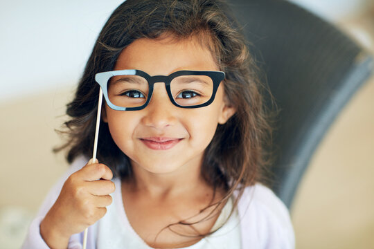 Glasses, costume and portrait of girl in home for smile, eye care and prescription lens. Happiness, ophthalmology and sight health with child and frame in apartment for eyewear and healthcare