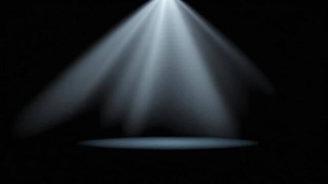 Bright White Spotlight Beam with Visible Rays on Dark Stage Floor