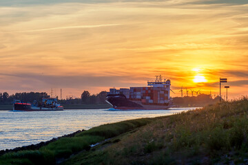 Obraz premium Cargo ships on canal at sunset, logistics and industry