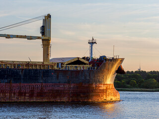 Fototapeta premium Bulk carrier ship sailing on the Noordzee Canal at sunset
