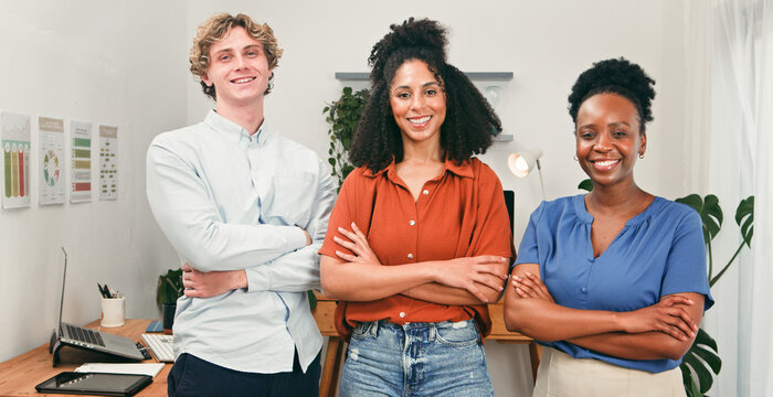 Three Confident Colleagues Standing Together in a Modern Office for Teamwork and Collaboration