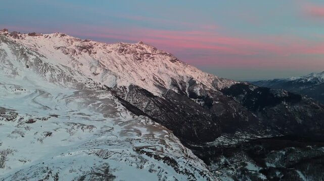 Snowy mountains at sunset create a serene winter landscape