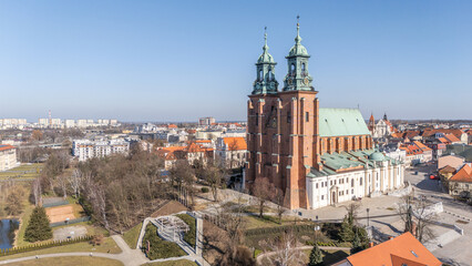 Naklejka premium 6 march 2025, Poznan, Poland. Aerial, drone view of The Archcathedral Basilica of St. Peter and St. Paul in Poznań. Ostrów Tumski, Cathedral island with the olders cathedral of Poland. Winter time.