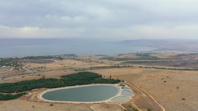 Aerial view of the unique water reservoir in the shape of a giant's footprint located at the Amiad Junction in the Upper Galilee overlooking the stunning Sea of ​​Galilee