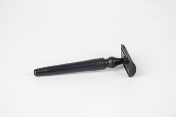A fake black razor in hand against on white background.