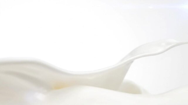 close up shot of fresh white milk splash against a clean white background with copy space