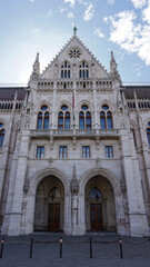 Fototapeta premium Entrance to the ornate neo-gothic Hungarian Parliament building. Located on the banks of the Danube River, in the center of Budapest