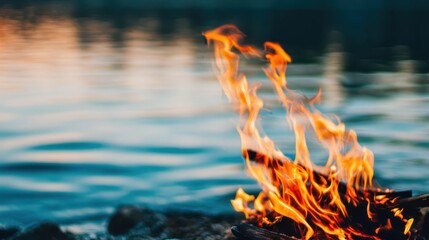 Fire burning near water outdoor nature scene photography calm environment close-up viewpoint vibrant flames