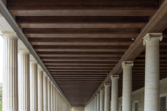 Classical Architecture of Stoa of Attalos in Athens Greece Featuring Doric and Ionic Marble Columns and Rhythmic Wooden Ceiling Beams in the Ancient Agora Archaeological Site