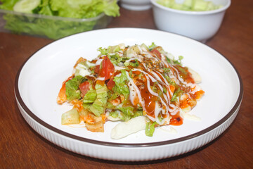 Delicious Loaded French Fries Topped with Fresh Salad and Mixed Sauces