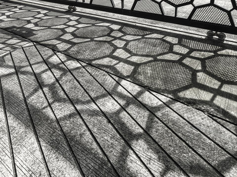 Black and White High Contrast Shadow of Perforated Metal Fence