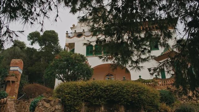 Mediterranean Villa Facade Framed By Pine, Lush Garden And Winding Stone Pathway Cinematic Drone Reveal With Ornate Windows,