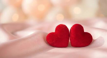 Fototapeta premium Red heart shaped cushions on white bedsheet with soft warm sunlight romantic love background