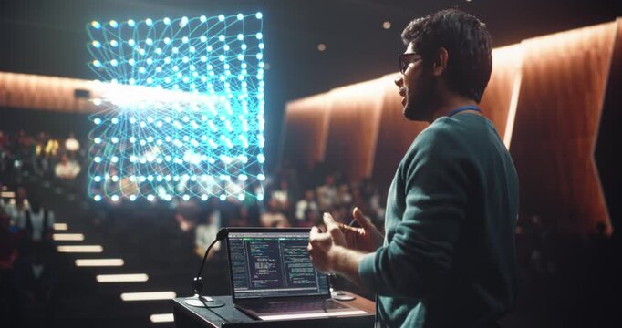 Professor Presents a Computer Science Lecture From a University Podium as a Glowing Hologram Shows Data Neural Netword Grid. Using Laptop Software Code to Explain AI Programming Talk to Auditorium