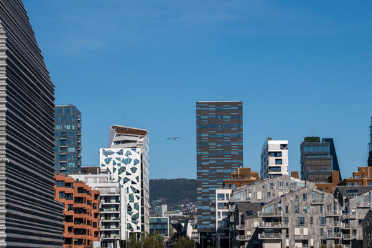 Panorama of urban skyline and modern buildings in Oslo Norway Barcode captures cityscape architecture under wide blue sky daylight scene