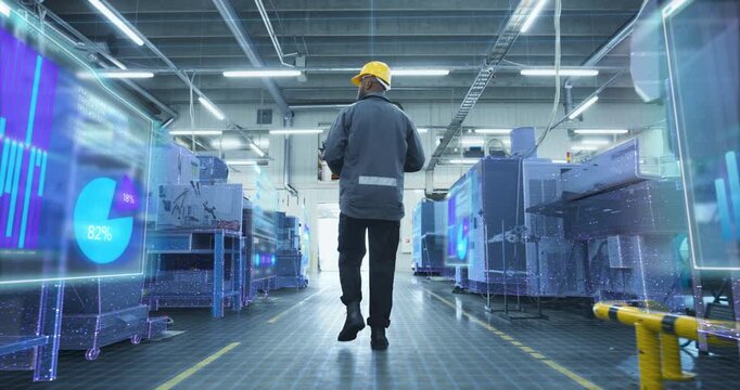 Technician Walks through Factory Holographic Infographics Data Show on CNC Machinery, Streaming Sensor Metrics, Status for Smart Manufacturing, Automation, Monitoring, Production Optimization