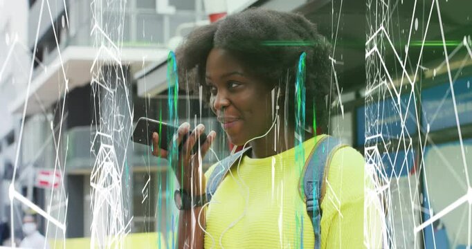 Animation of abstract pattern over african american woman talking on phone wearing headphones