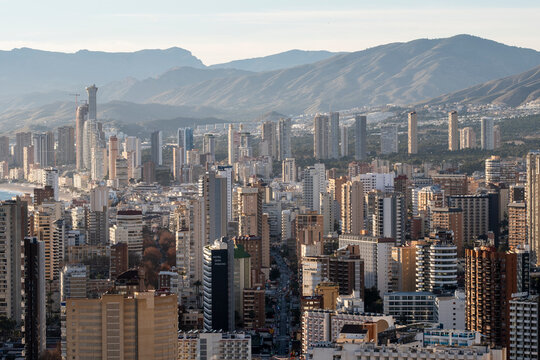 Aerial daytime cityscape with buildings skyline architecture and urban mountains on the horizon in benidorm spain from high viewpoint panorama