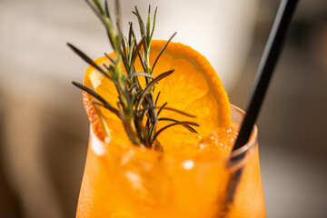 Close up of Aperol Spritz cocktail with orange slice and bubbles. Highlights sparkle, freshness, and vibrant color of summer aperitif.