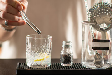 Close up of gin cocktail with lime slice and ice cubes at bar. Represents clarity, freshness, and elegant modern mixology style