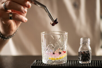 Bartender preparing gin infused with aromatic spices and herbs. Captures fragrance, craftsmanship, and freshness of handcrafted mix.