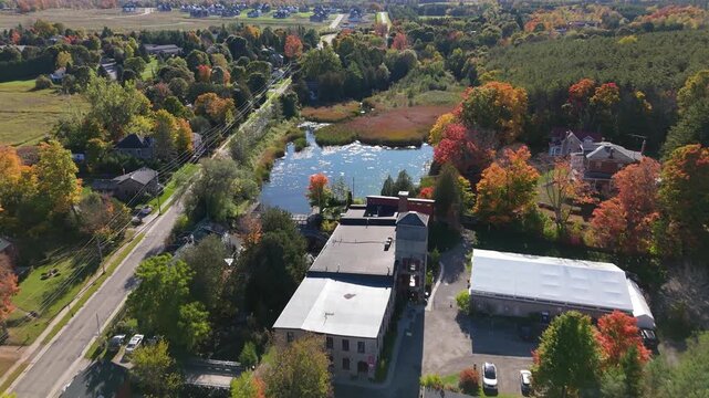 Aerial Drone Landscape of The Alton Mill with Autumn Trees and Lakeside Road in Caledon, Ontario, Canada
