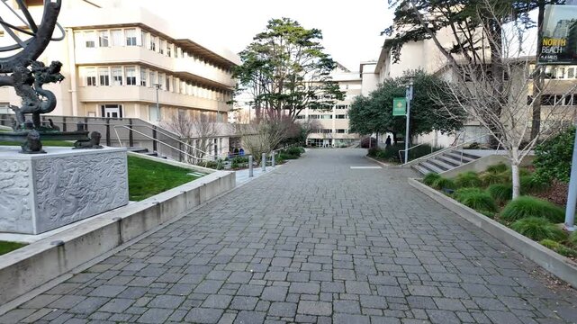 A ground-level campus walk at the University of San Francisco highlights architectural contrasts, statues, and peaceful outdoor spaces shaped by the city&rsquo;s unique geography.