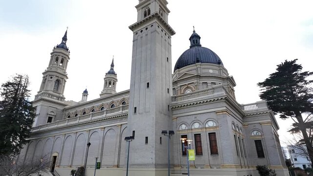 An upward view of Ignatius Church highlights its bold fa&ccedil;ade and towers rising above the USF campus, framed by San Francisco skies. Filmed in 4K.