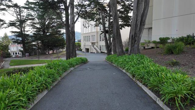 A walking point of view through the University of San Francisco reveals hilltop pathways, historic buildings, and city vistas, capturing the rhythm of campus life.
