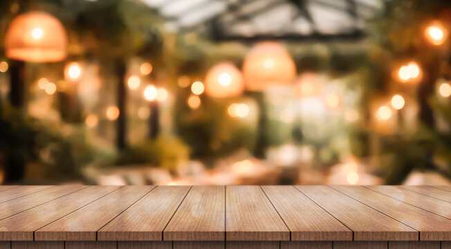Empty wooden table top with lights bokeh on blur restaurant background
