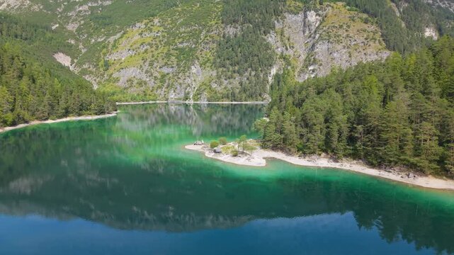 Aerial view of Lake Blindsee in Tyrol, Austria. A crystal-clear mountain lake nestled in the Austrian Alps. A natural tourist destination