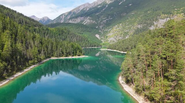 Aerial view of Lake Blindsee in Tyrol, Austria. A crystal-clear mountain lake nestled in the Austrian Alps. A natural tourist destination