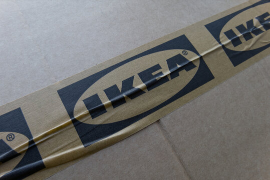 Zurich, Switzerland - January 5, 2026: A close-up of a cardboard box wrapped in packaging tape with the Ikea logo printed on it. A delivered but unopened order from the furniture store.