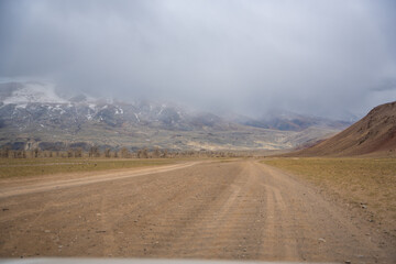 Gravel road through deserted valley leading from Mars Altai Russia. Remote pathway to famous...