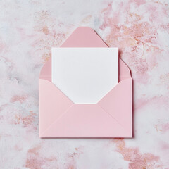 White blank card in a pink envelope.