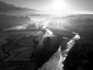 Beautiful morning view in Indonesia, panoramic landscape of rice fields with mountain ranges and clear sky