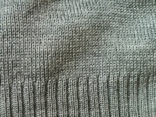 Macro Texture of Grey Knitted Wool Fabric - Detailed Background of Ribbed Jersey Stitch and Soft Winter Textile Fiber Pattern