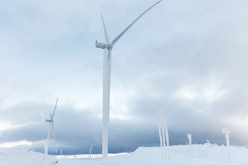 Offshore wind farm - Winter arctic industrial Wind turbine station on the mountain.