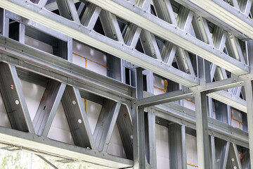 Metal stud framing system with rust resistant coating in a drywall assembly. Metal house frame. Construction of a private frame house. Steel wall frames. Construction background, house construction.