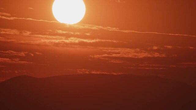 Extreme Closeup of Red Sunset Over a Hill Zoom In Timelapse