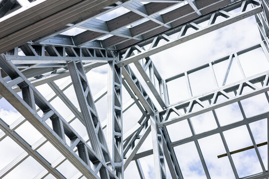 New home construction framing. Metal stud framing system with rust resistant coating in a drywall assembly. Structure of steel for building construction. Metal house frame.