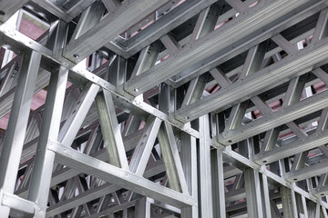 New home construction framing. Metal stud framing system with rust resistant coating in a drywall assembly. Structure of steel for building construction. Metal house frame.