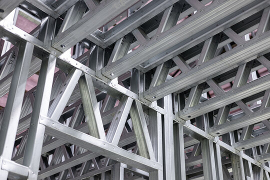 New home construction framing. Metal stud framing system with rust resistant coating in a drywall assembly. Structure of steel for building construction. Metal house frame.