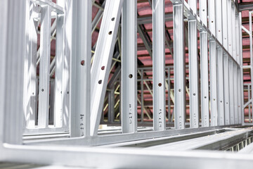 Obraz premium New home construction framing. Metal stud framing system with rust resistant coating in a drywall assembly. Structure of steel for building construction. Metal house frame.