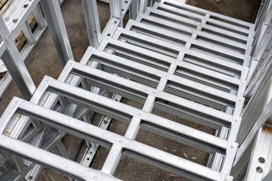 Close-up of a galvanized light steel frame (LSF) staircase structure on a construction site. This modern pre-fabricated metal stair system is used in modular building for quick and efficient assembly