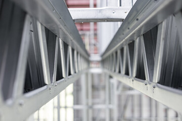 New home construction framing. Metal stud framing system with rust resistant coating in a drywall assembly. Structure of steel for building construction. Metal house frame.